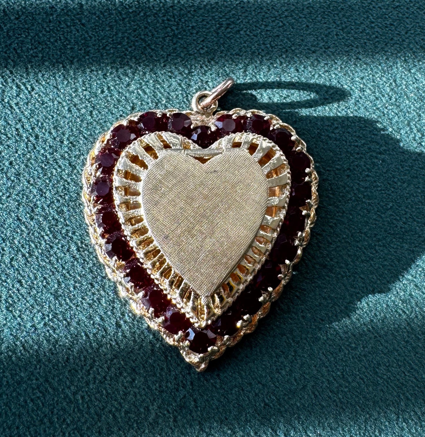 Heart-shaped jewelry piece with a blue background