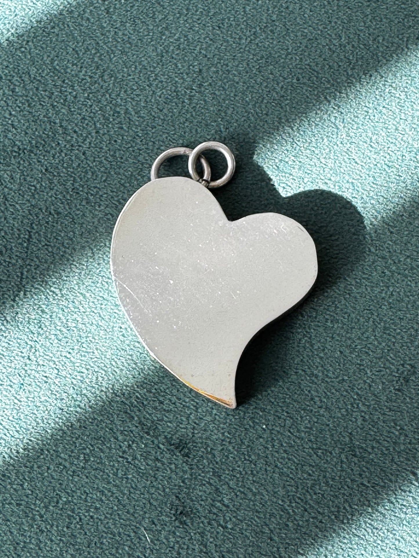 Heart-shaped pendant on a light blue background