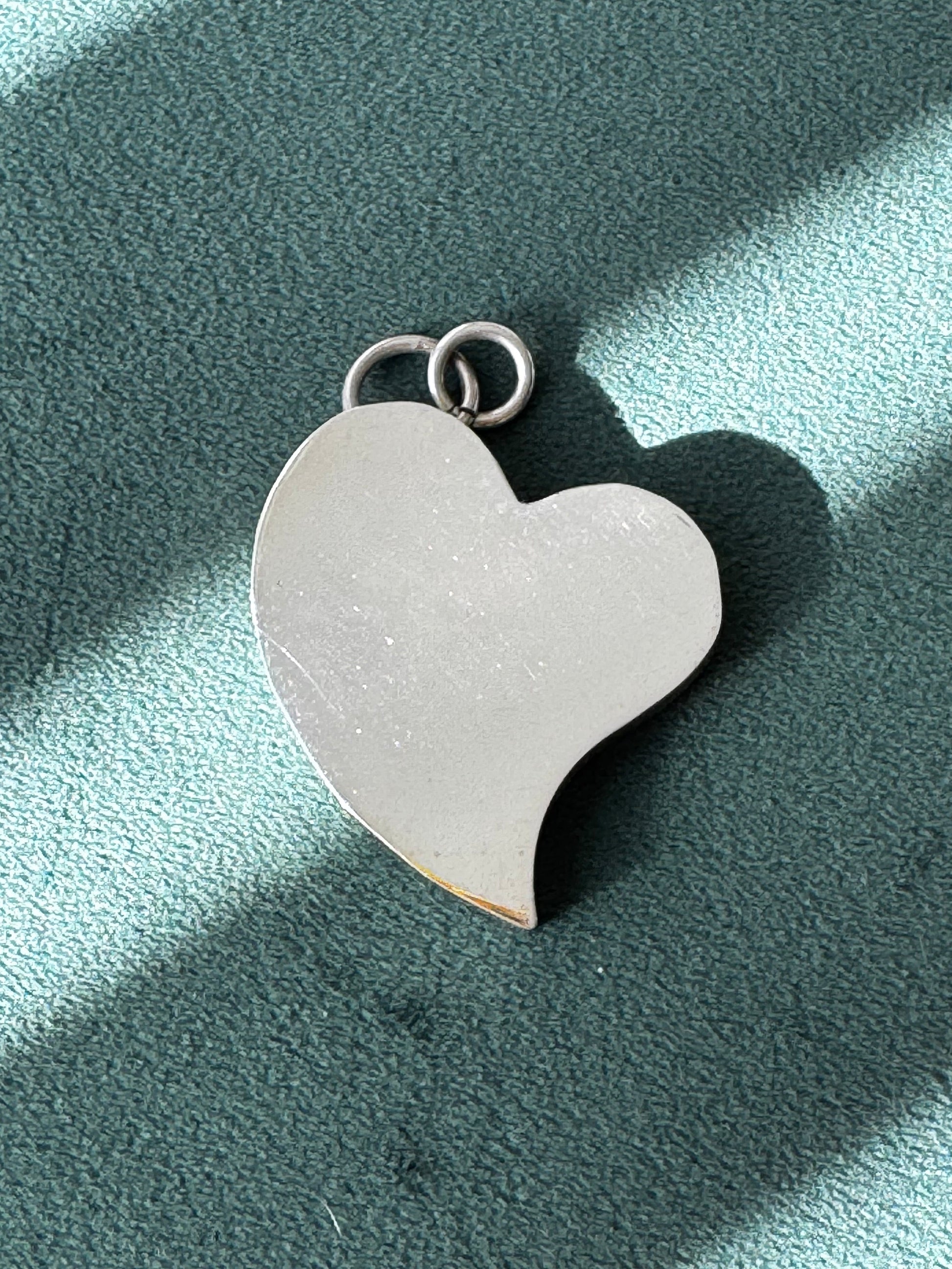 Heart-shaped pendant on a light blue background
