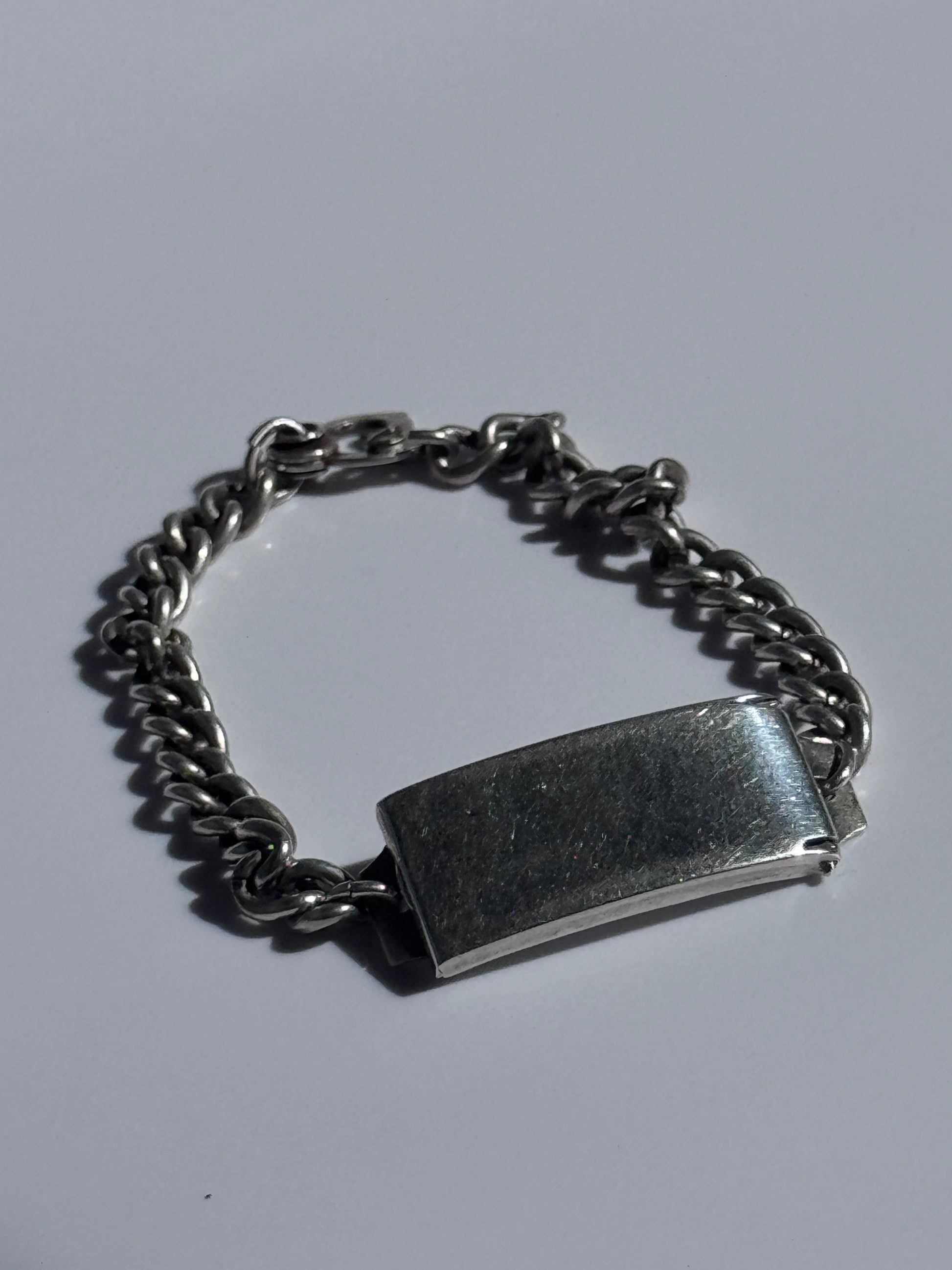 Vintage WWII sterling silver ID bracelet with curb chain and secret locket compartment, estate condition with engravable surface