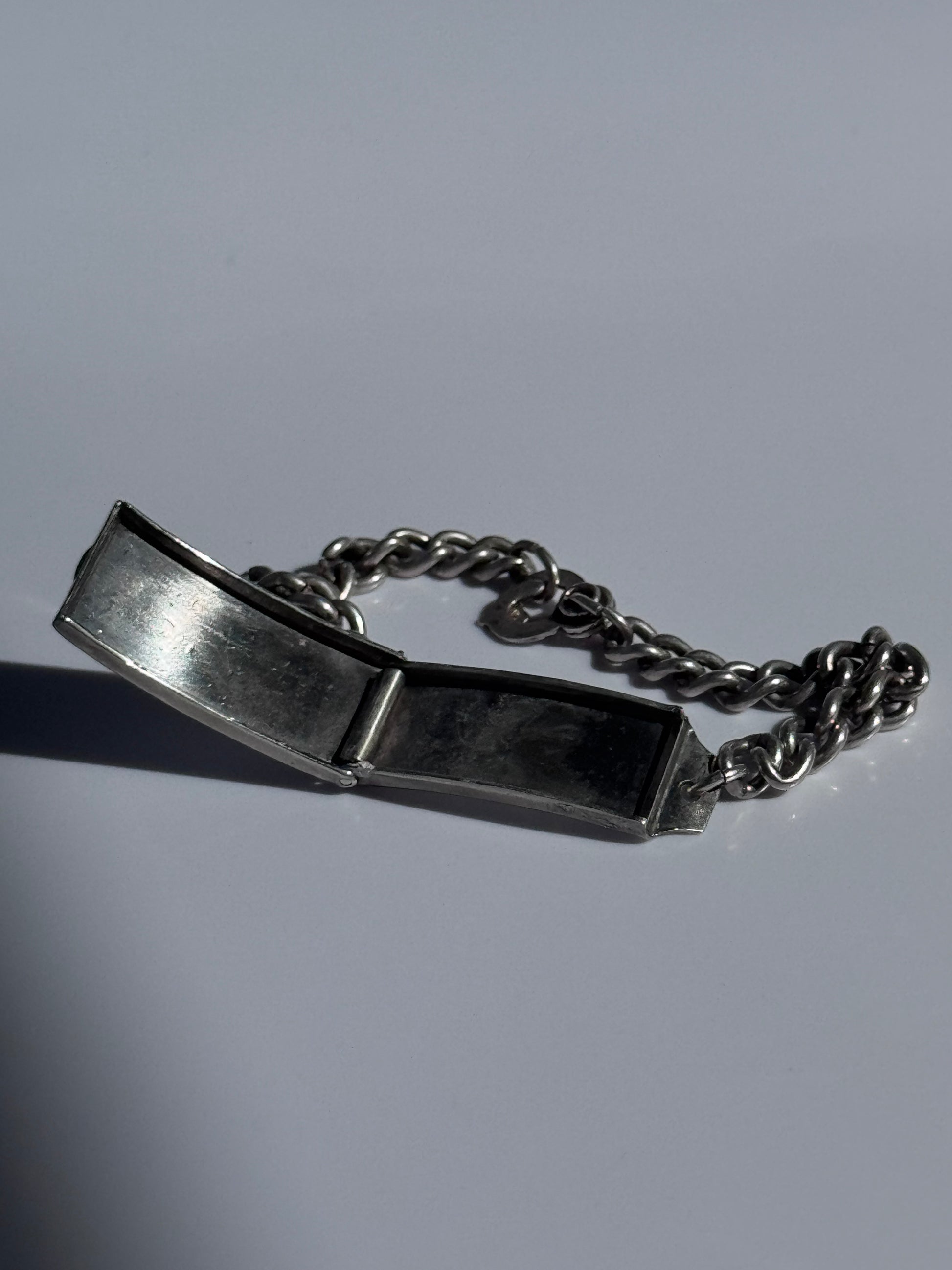 Vintage WWII sterling silver ID bracelet with curb chain and secret locket compartment, estate condition with engravable surface