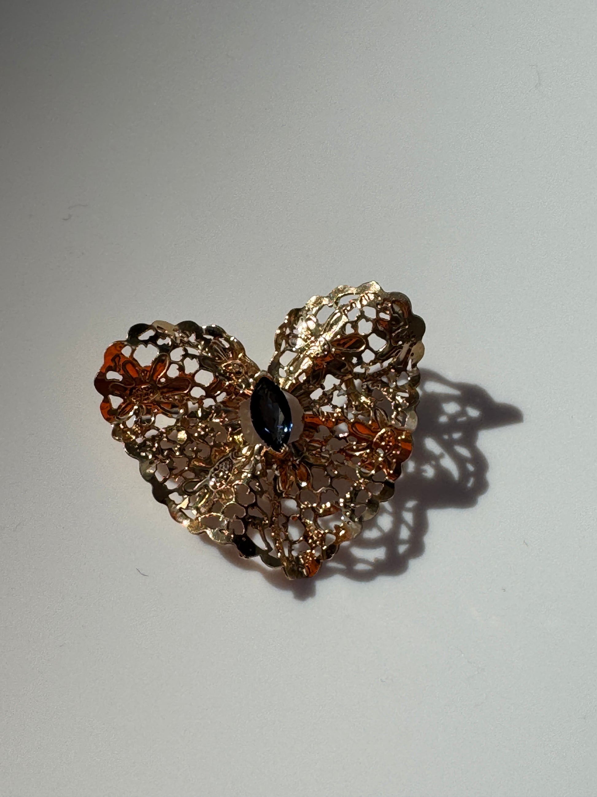 Estate 1980s 14K yellow gold heart slide pendant with blue sapphire centerstone and intricate pierced filigree openwork design