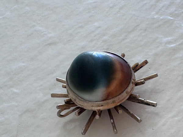 1940s sterling silver sunburst pendant with natural operculum center, WWII era modernist design with gold wash