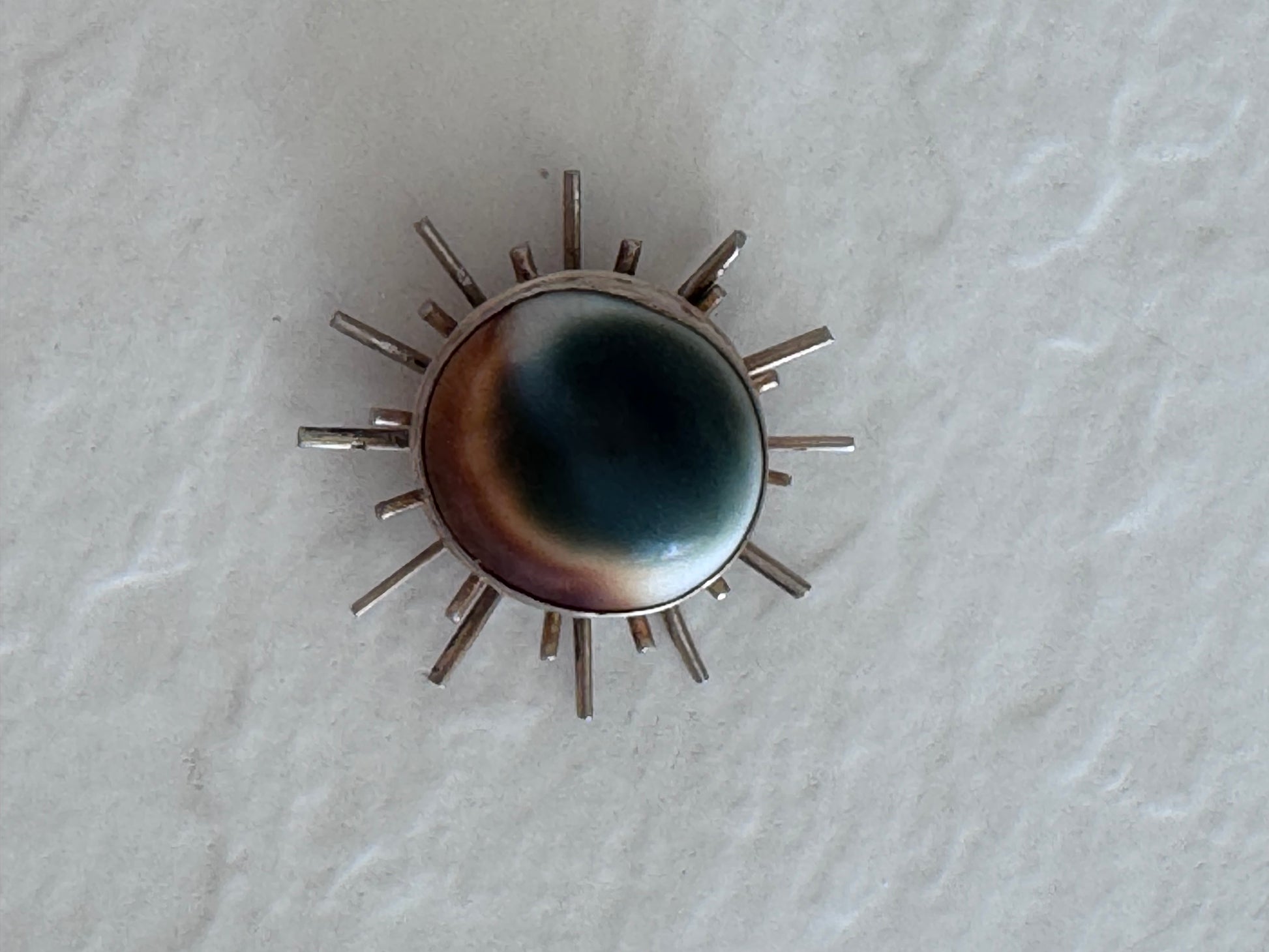 1940s sterling silver sunburst pendant with natural operculum center, WWII era modernist design with gold wash