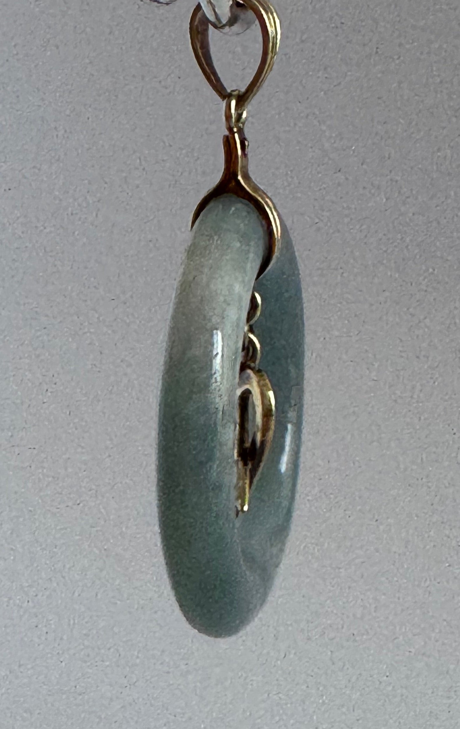 Estate vintage 14K yellow gold blue jadeite circle pendant with heart and arrow motif, showing translucent stone and quality gold framework