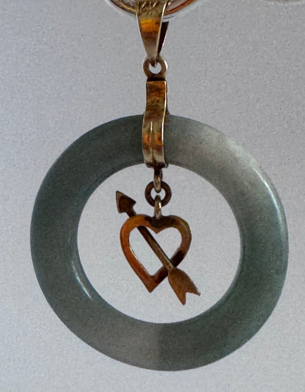 Estate vintage 14K yellow gold blue jadeite circle pendant with heart and arrow motif, showing translucent stone and quality gold framework