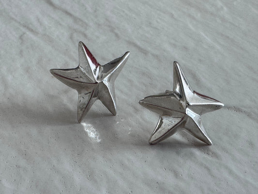 Estate sterling silver dimensional puffy star stud earrings with mirror finish, approximately half inch, showing quality construction