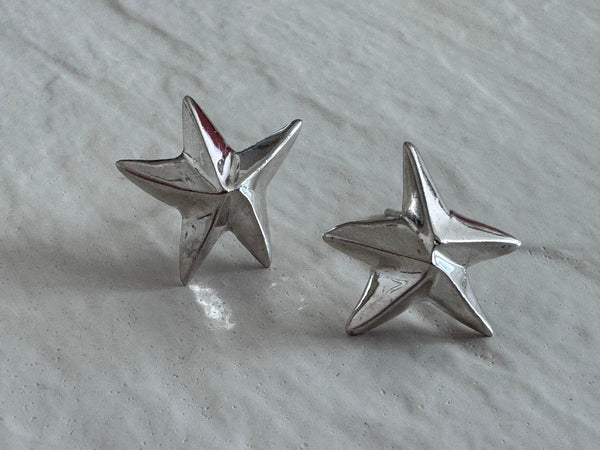 Estate sterling silver dimensional puffy star stud earrings with mirror finish, approximately half inch, showing quality construction