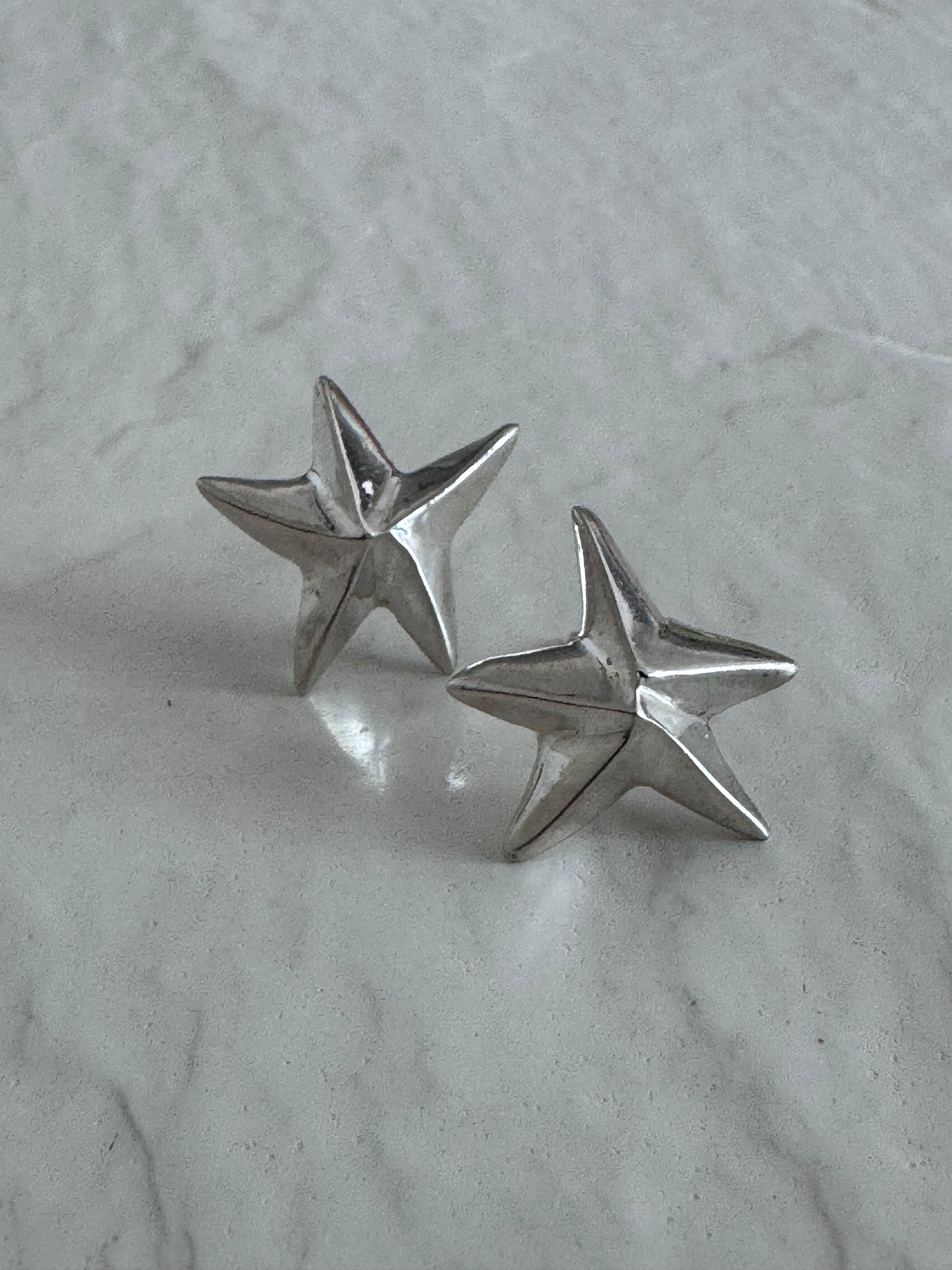 Estate sterling silver dimensional puffy star stud earrings with mirror finish, approximately half inch, showing quality construction