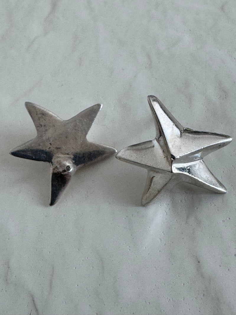 Estate sterling silver dimensional puffy star stud earrings with mirror finish, approximately half inch, showing quality construction