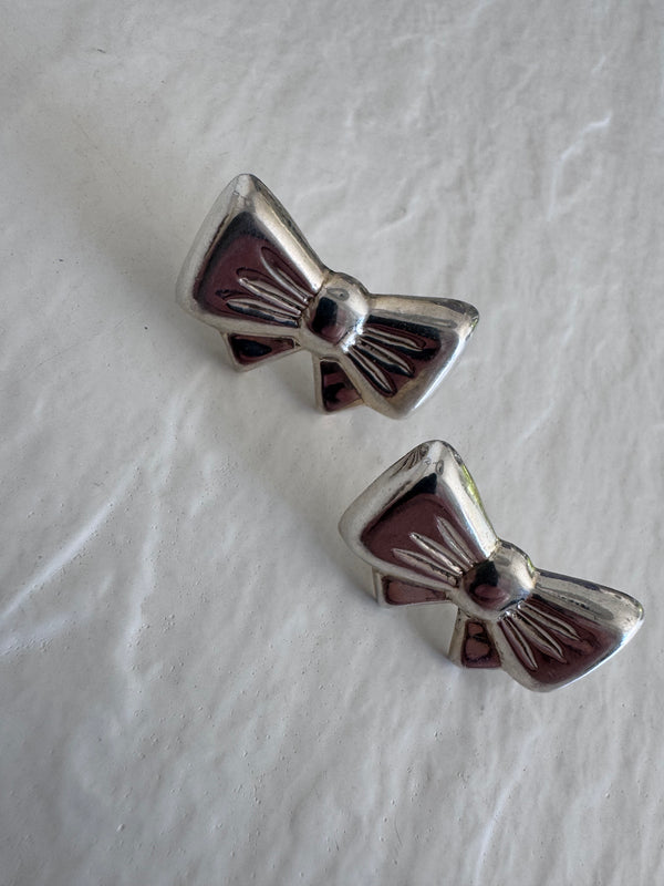Vintage sterling silver bow earrings with detailed fabric texturing, 925 hallmark and mystery maker's mark, perfect for rockabilly pin-up style