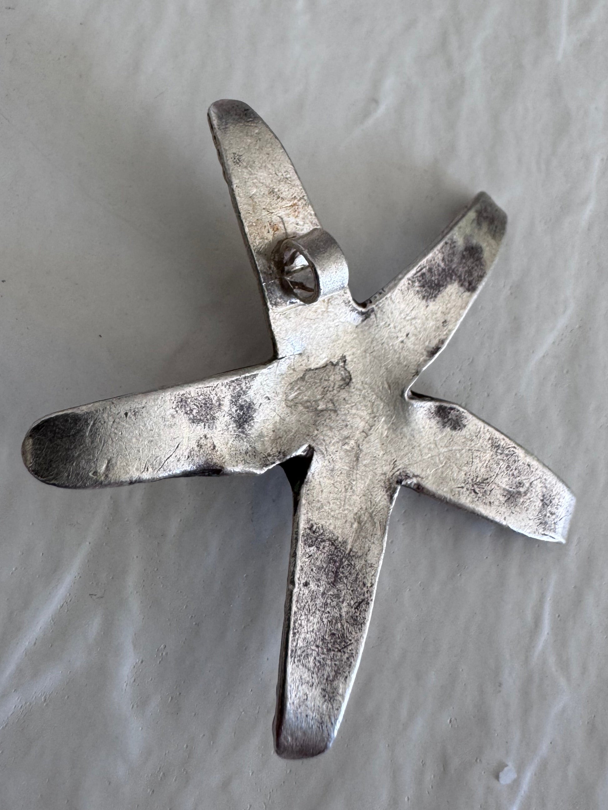 Large Karen Hill Tribe silver starfish pendants with textured surface showing authentic handcrafted details and hidden bail construction