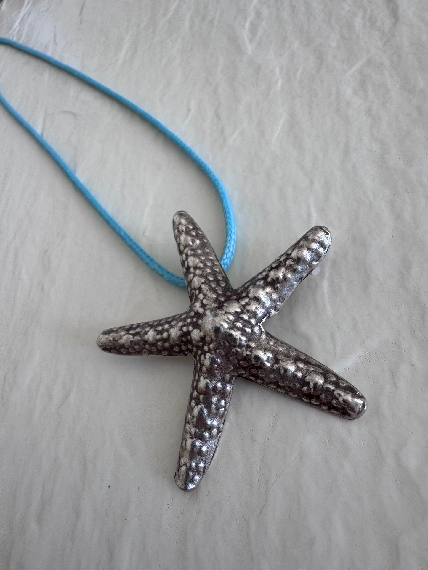 Large Karen Hill Tribe silver starfish pendants with textured surface showing authentic handcrafted details and hidden bail construction