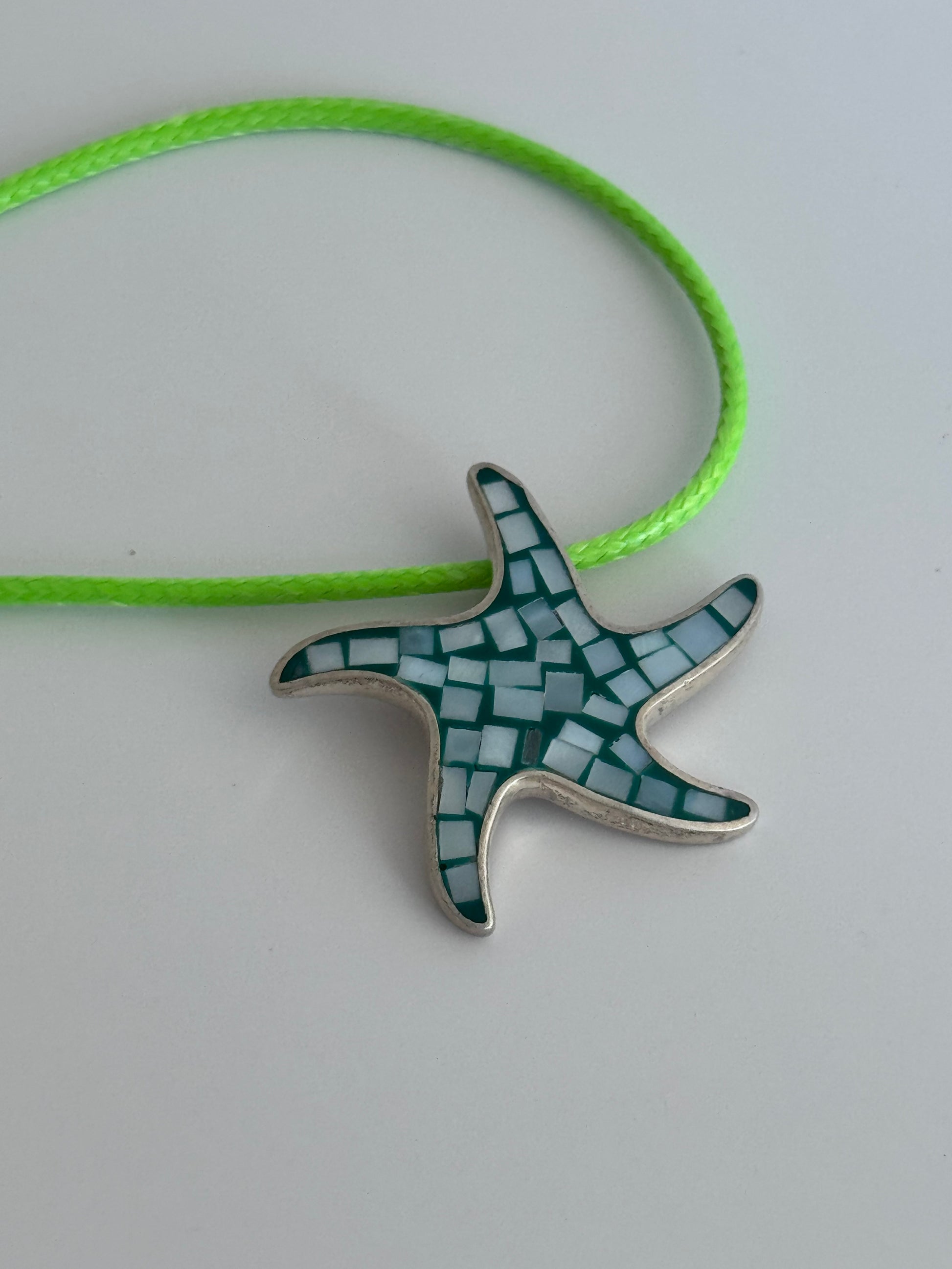 Vintage sterling silver starfish pendant with mother of pearl and green resin mosaic inlay, showing detailed craftsmanship and 925 hallmark