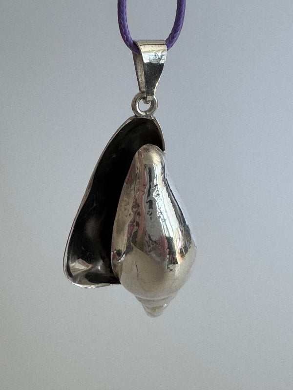 Large vintage sterling silver conch shell pendant with high-polish finish, showing detailed spiral shell design and secure bail