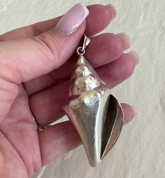 Large estate sterling silver conch shell pendant 2.75 inches long with hammered texture and included 14 inch chain, showing detailed spiral chambers