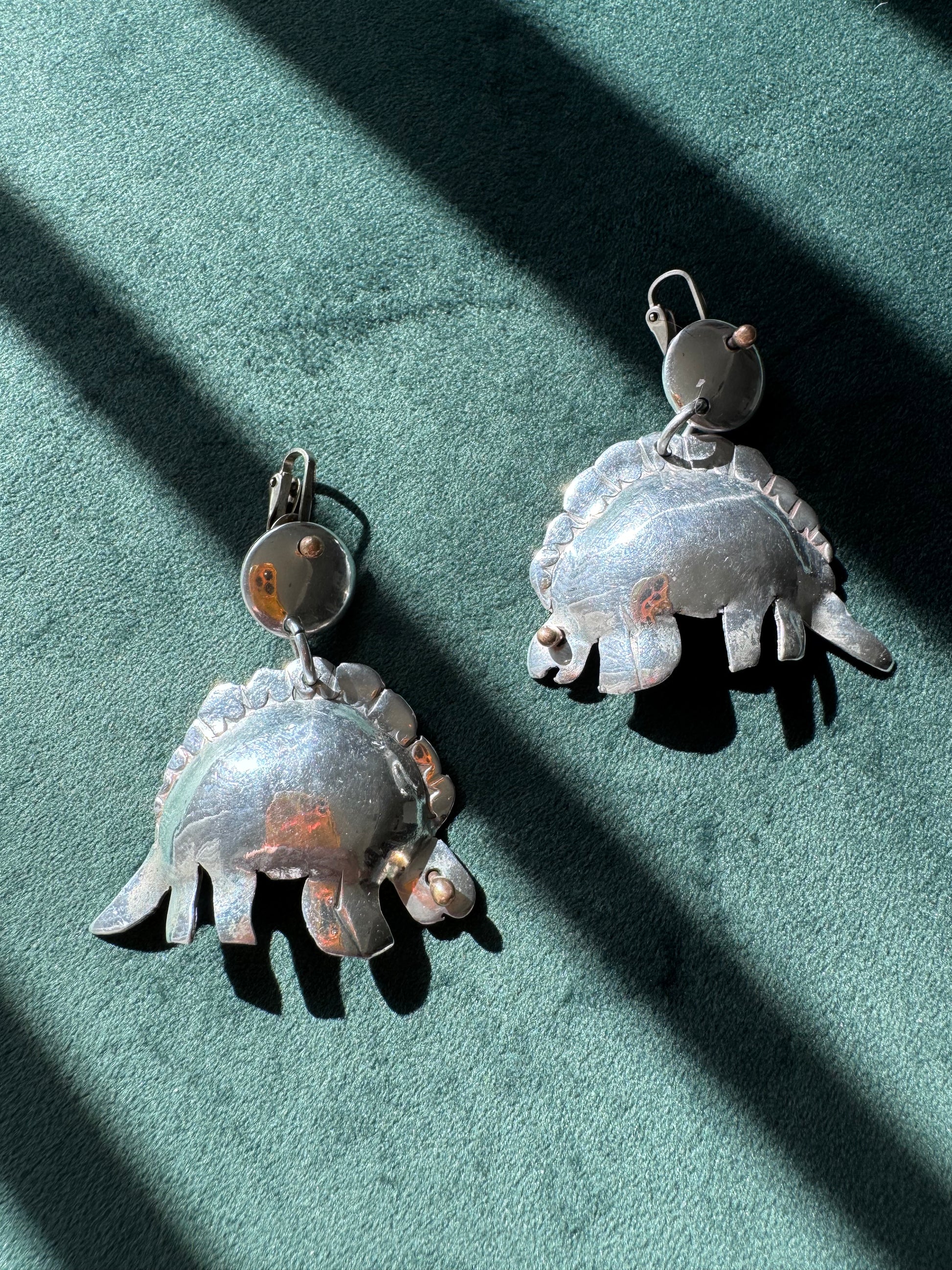 Large vintage silver stegosaurus dinosaur statement dangle clip-on earrings with gold-tone accents, handmade oversized hollow-form construction