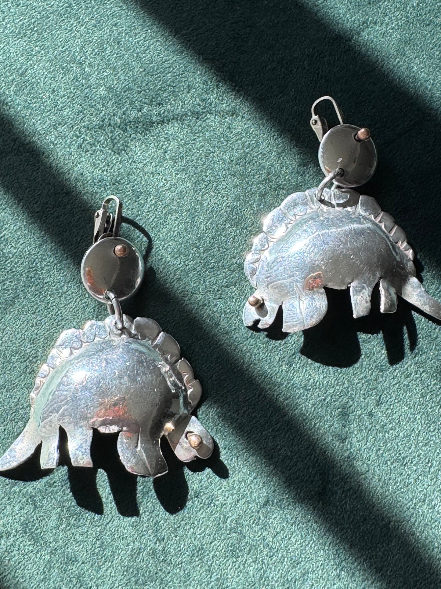 Large vintage silver stegosaurus dinosaur statement dangle clip-on earrings with gold-tone accents, handmade oversized hollow-form construction