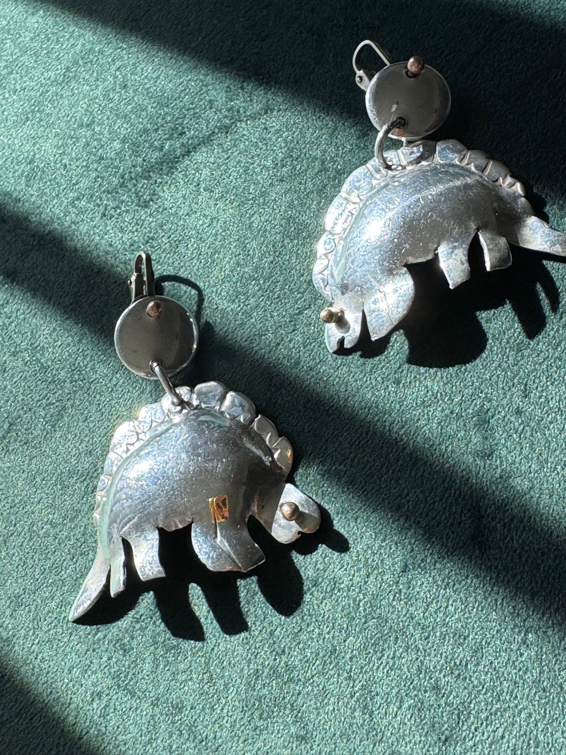 Large vintage silver stegosaurus dinosaur statement dangle clip-on earrings with gold-tone accents, handmade oversized hollow-form construction