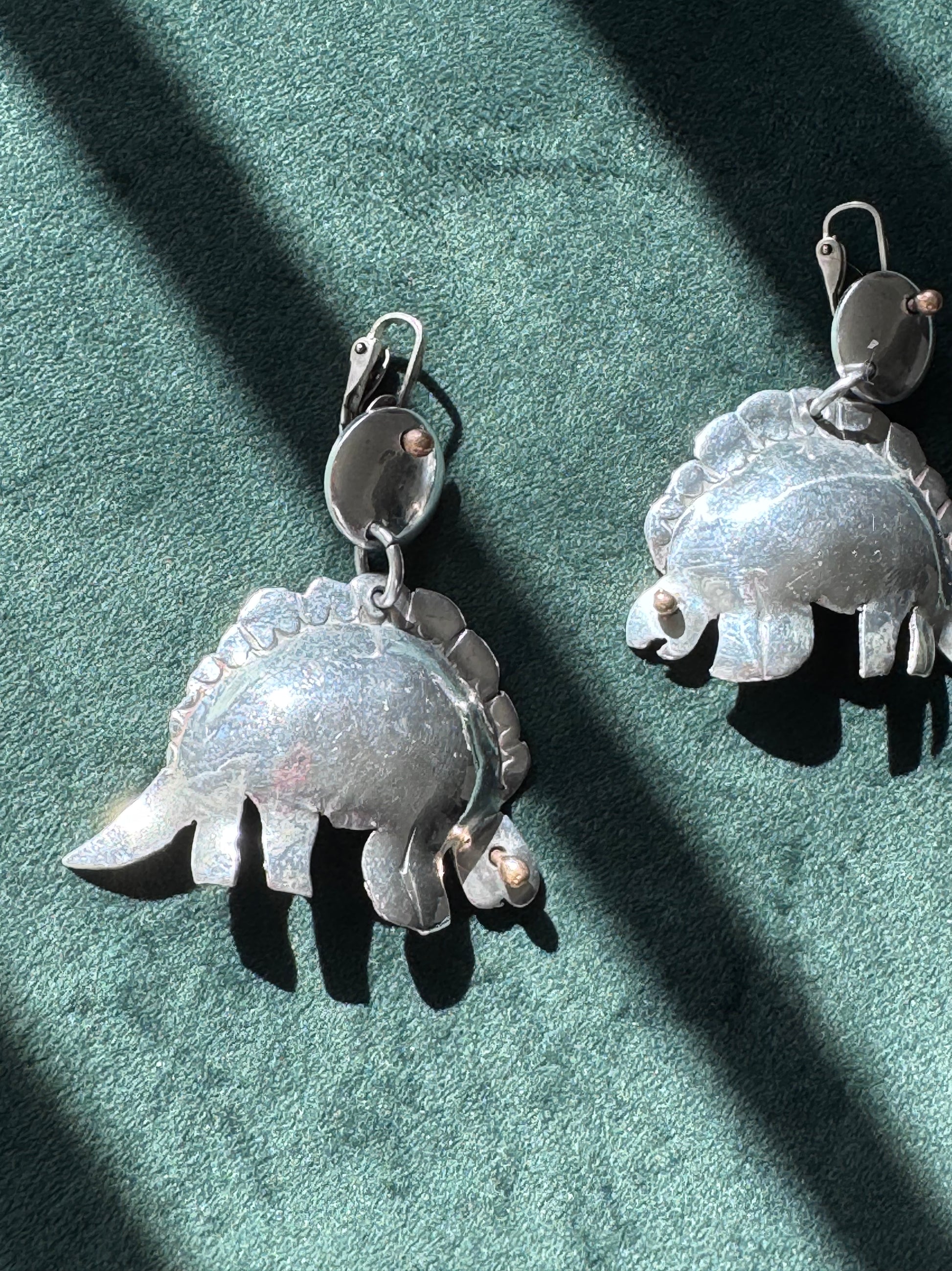 Large vintage silver stegosaurus dinosaur statement dangle clip-on earrings with gold-tone accents, handmade oversized hollow-form construction