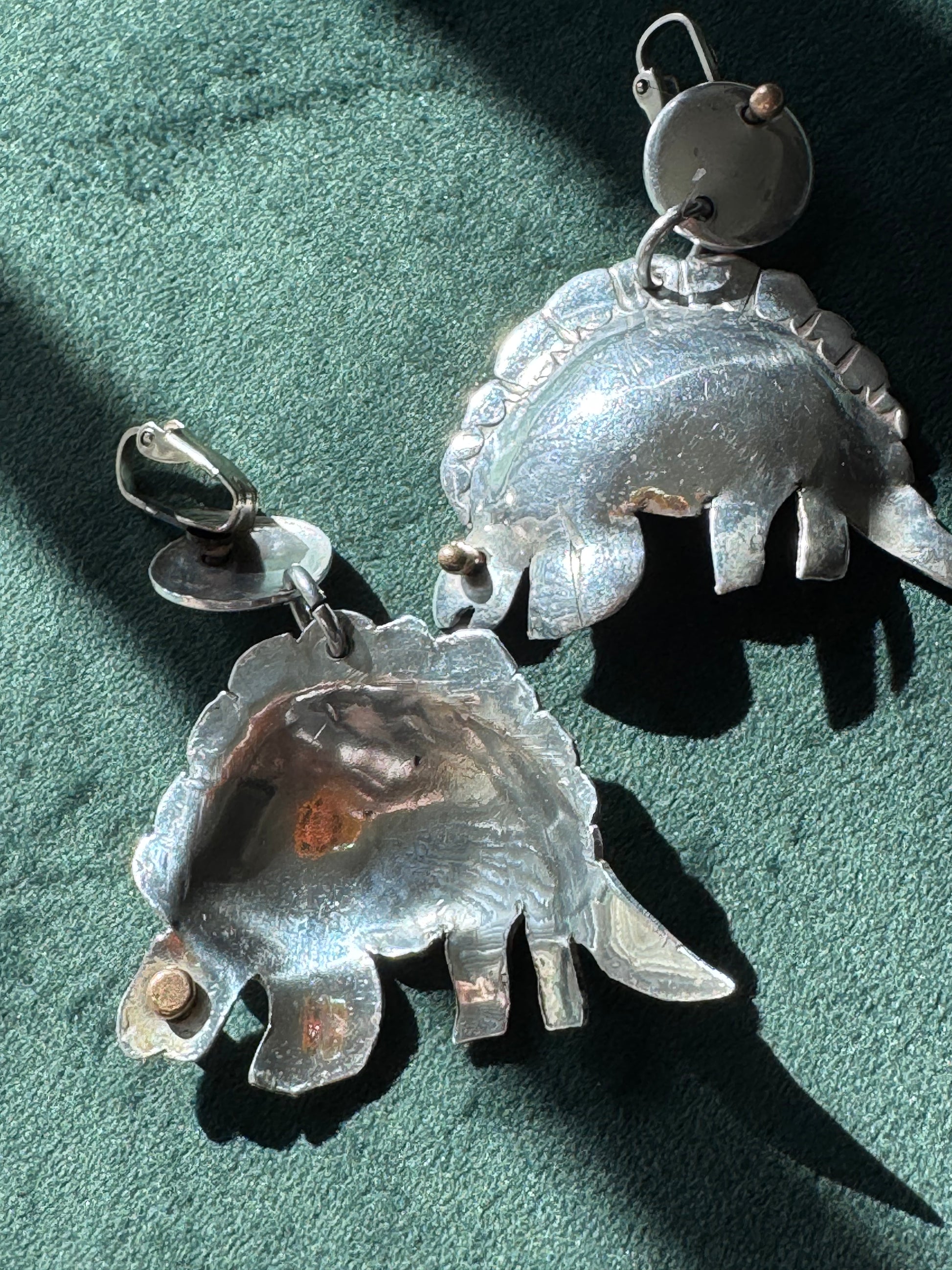 Large vintage silver stegosaurus dinosaur statement dangle clip-on earrings with gold-tone accents, handmade oversized hollow-form construction