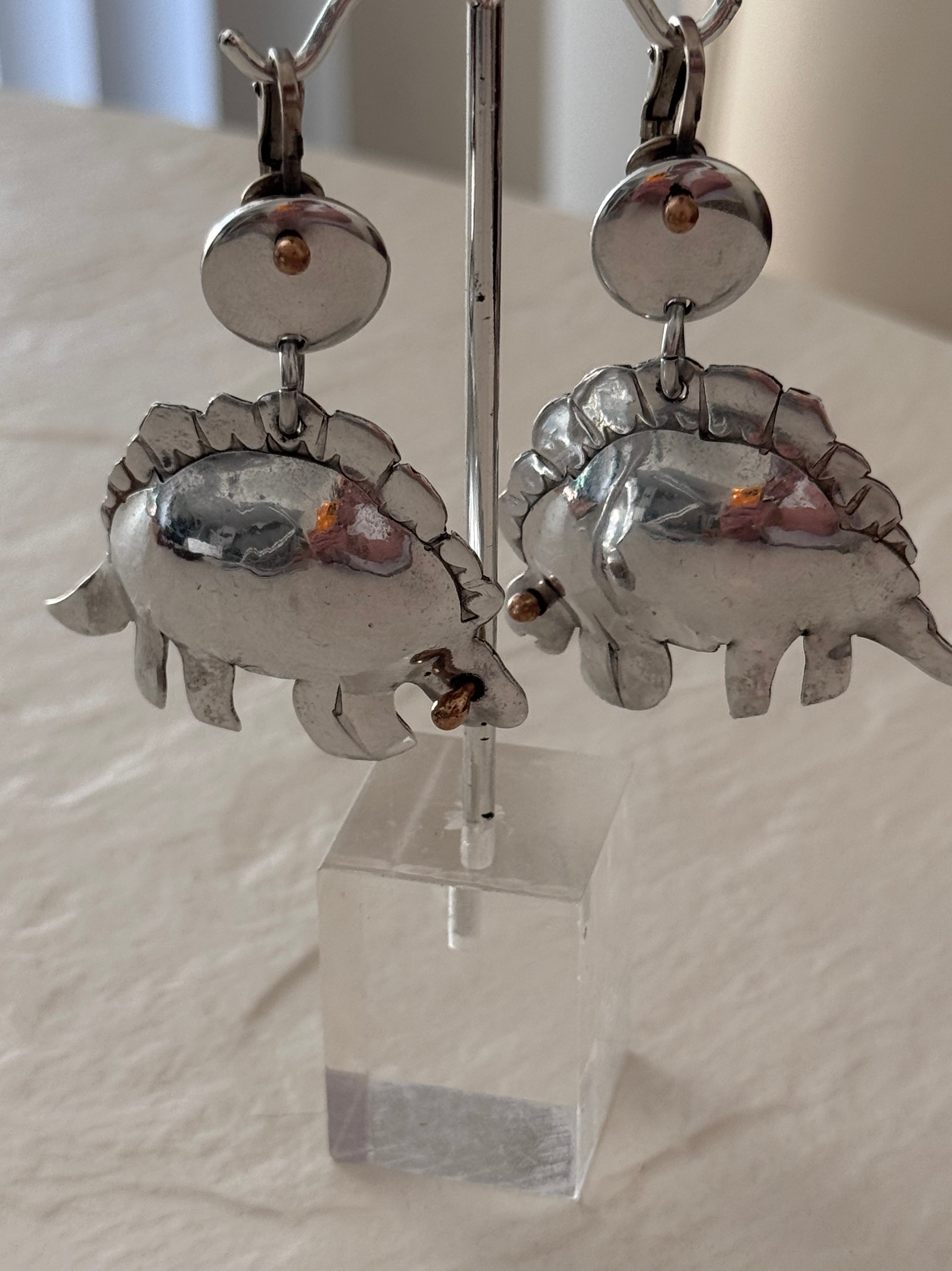 Large vintage silver stegosaurus dinosaur statement dangle clip-on earrings with gold-tone accents, handmade oversized hollow-form construction