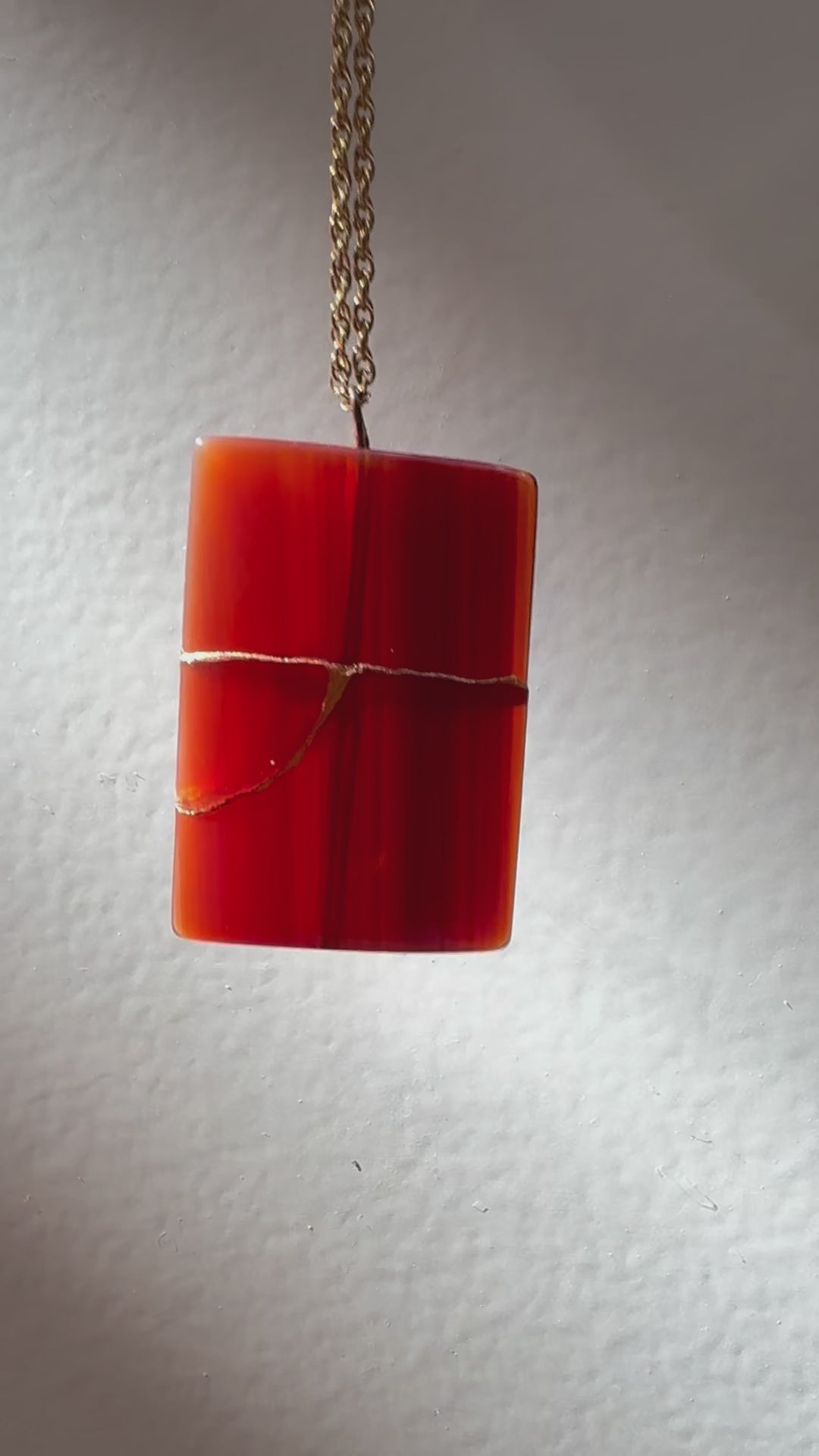 Estate 14K gold pendant featuring natural red carnelian rectangle with dramatic gold strike mineral inclusions embodying wabi sabi aesthetics