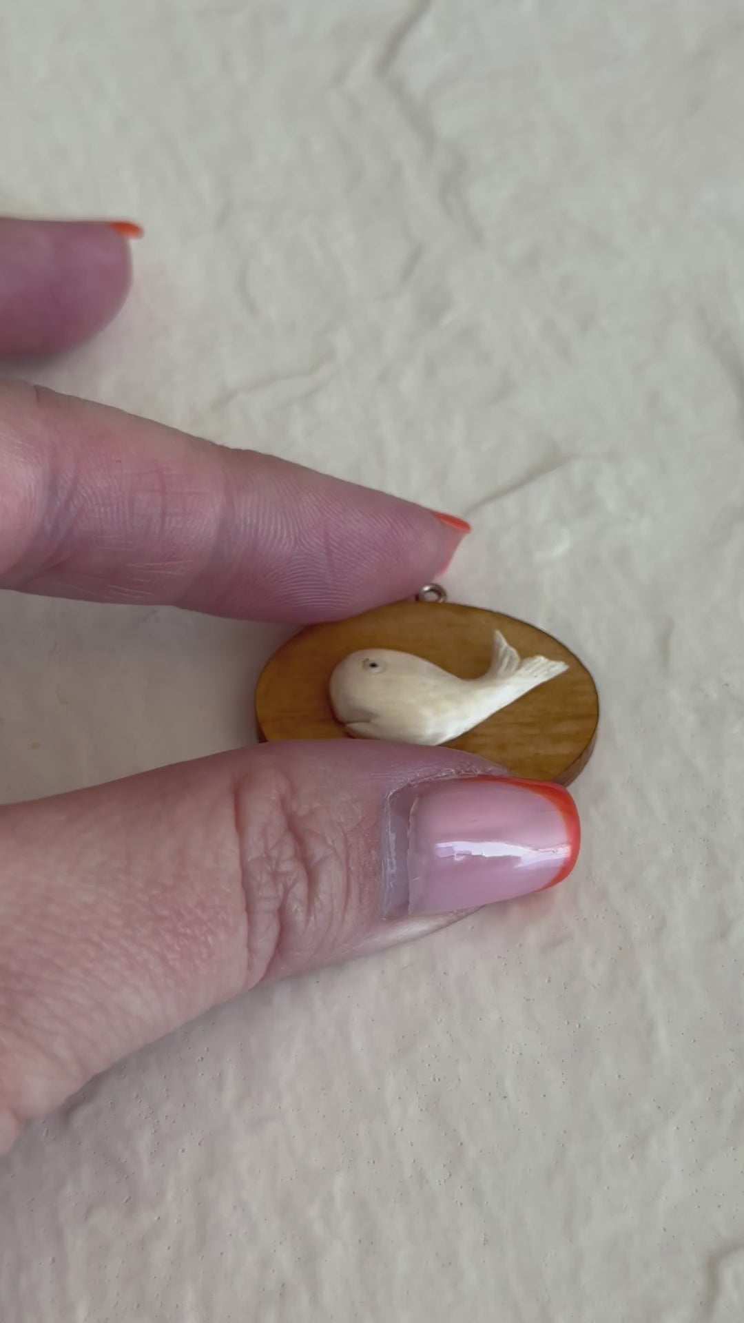 Vintage scrimshaw-style carved whale pendant on natural wood oval with sterling silver bail