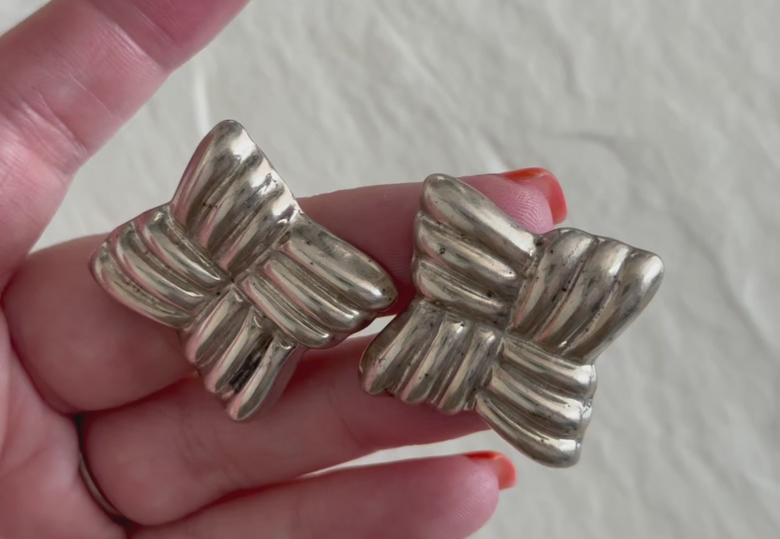 Estate Taxco Mexican sterling silver large puffy ribbon bow earrings with T925 Mexico hallmarks, showing dimensional ridged design