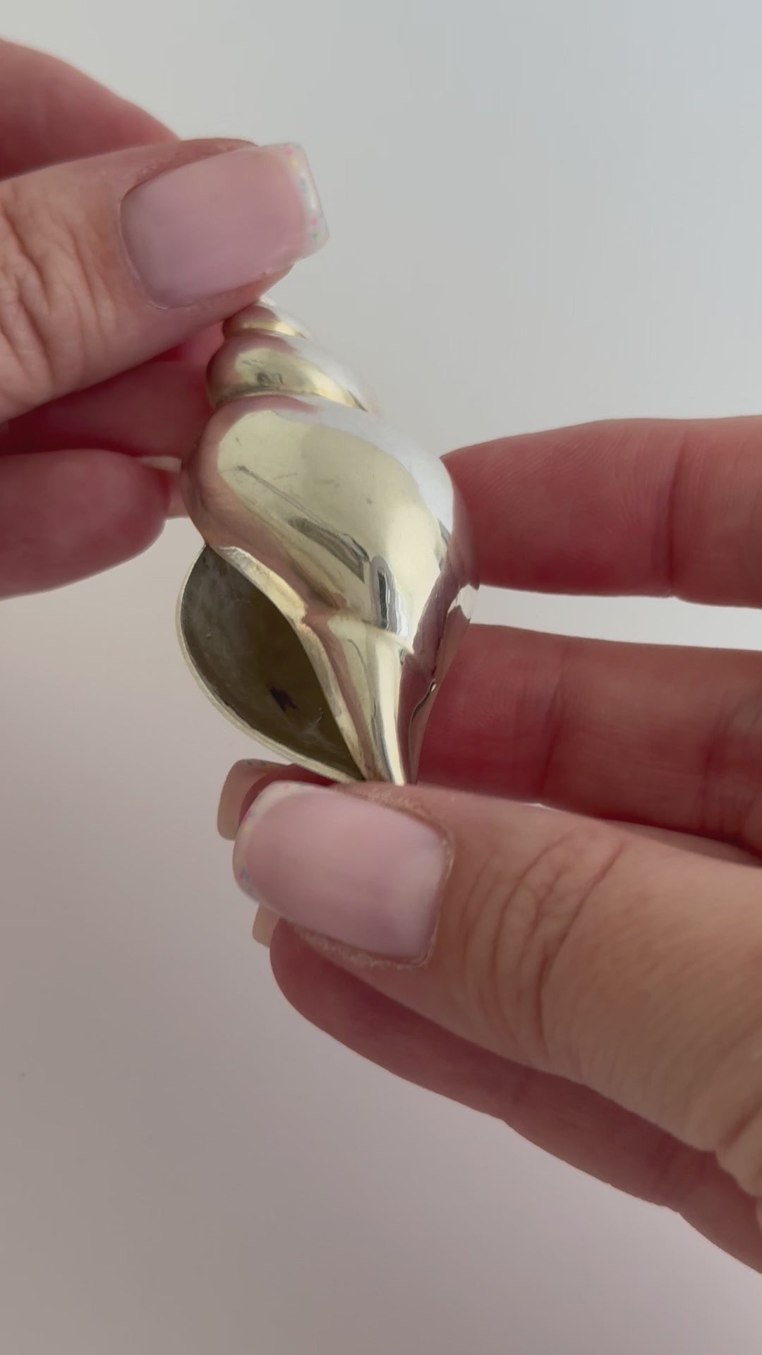 Large vintage sterling silver conch shell pendant with AI signature, showing detailed spiral shell design and high-polish finish