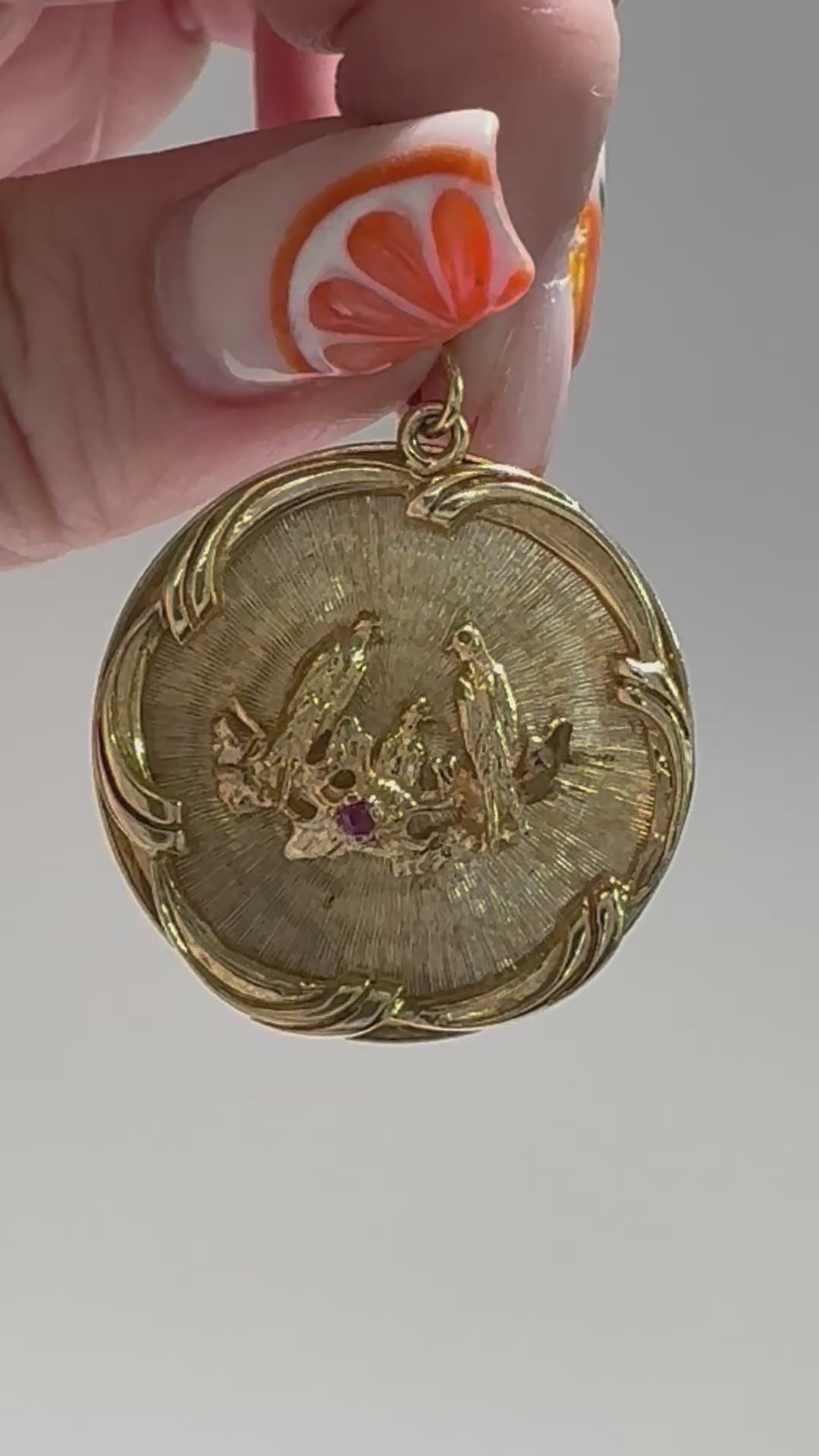 1950s 14K gold love birds medallion pendant with engine turned background and ruby accent, vintage romantic jewelry